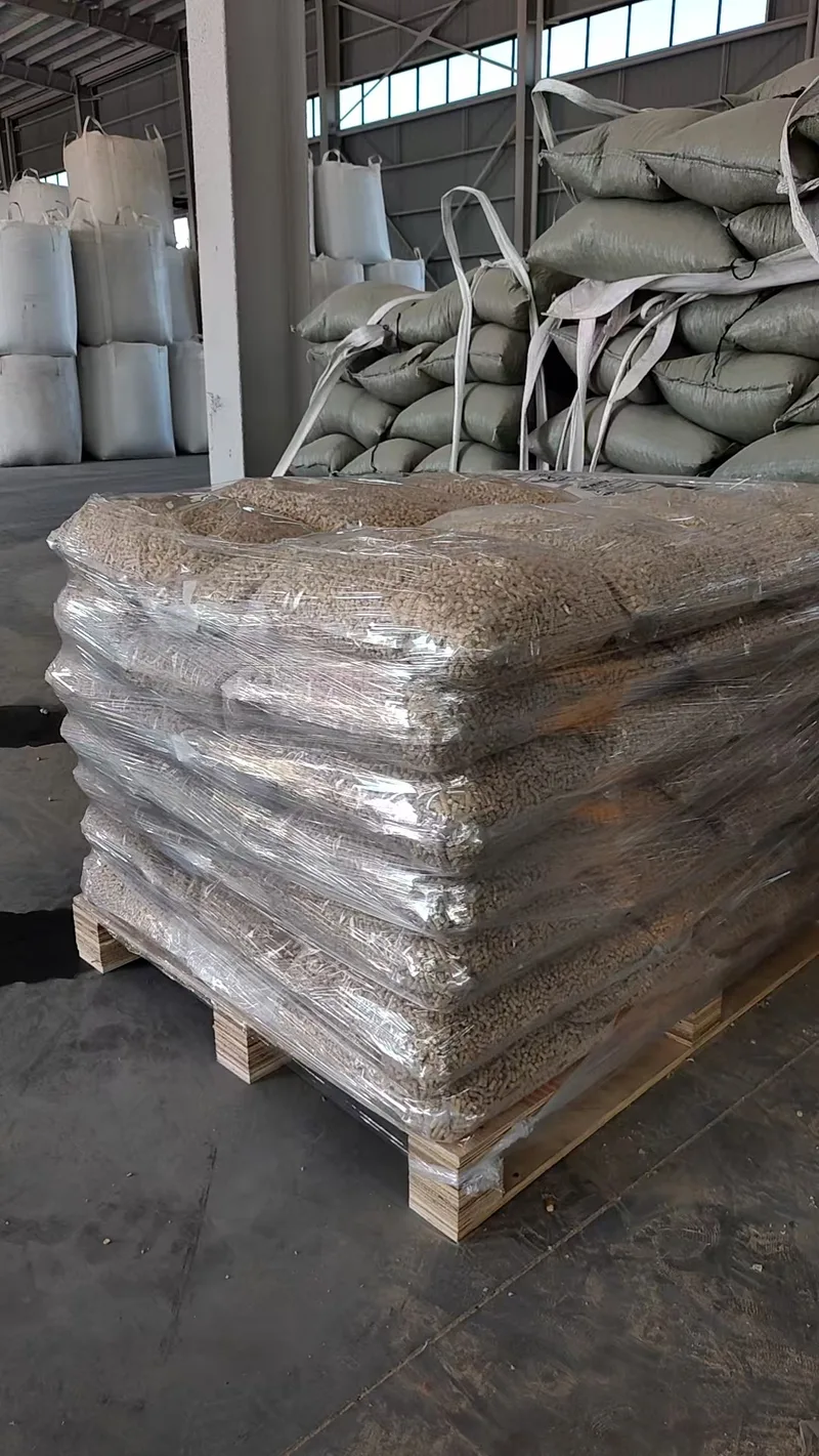 Transparent bags of wood pellets wrapped together on a wooden pallet inside a warehouse